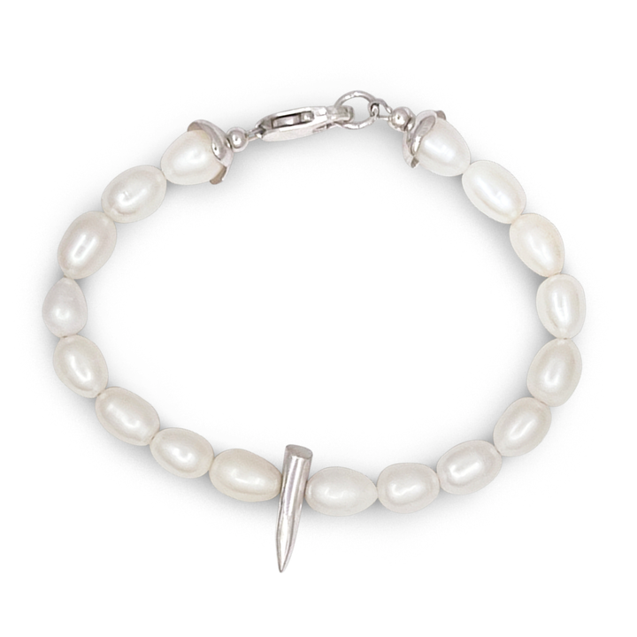 Pearl bracelet with a silver spike charm on a white background