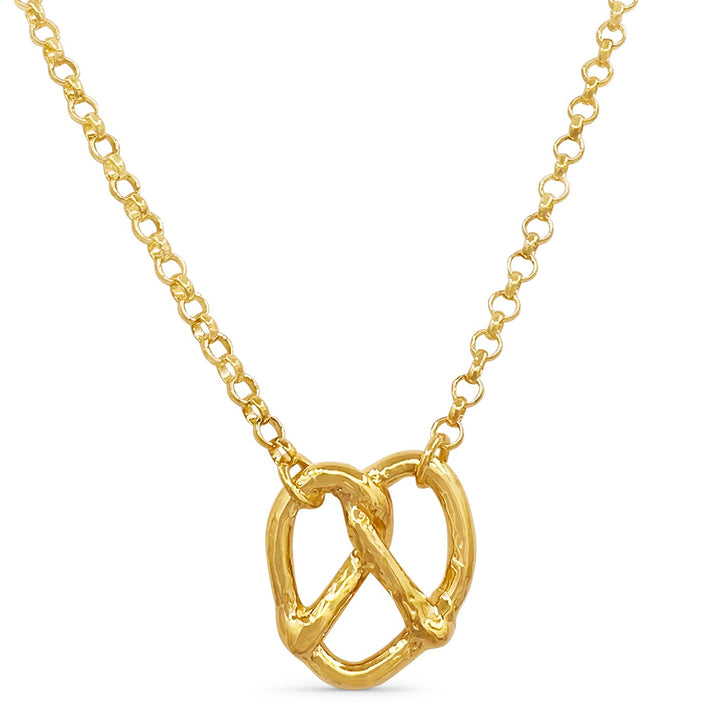 Gold necklace with a unique pendant on a white background