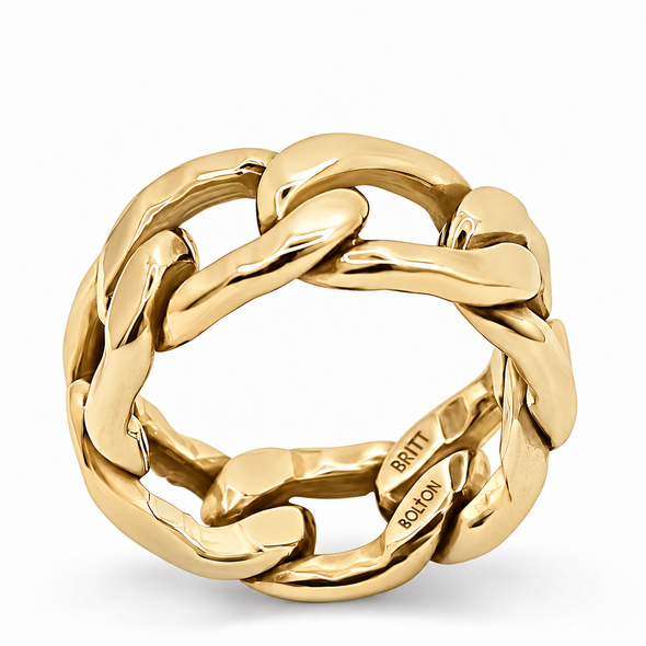 A polished yellow gold ring with a thick, interlocking curb-link design, shown on a clean white background. The brand name 'BRITT ROLO' is engraved on the inside of the band.