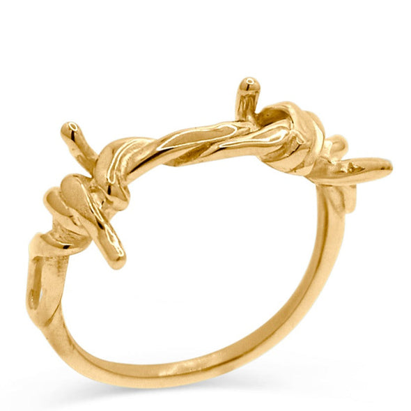 14k yellow gold ring made to look like literally barbed wire. standing upright and shot on white background.