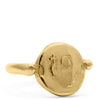14k yellow gold signet ring which is a coin with a thin band. The coin has an image of an abstract mother mary with a cross engraved in it. shot on white background
