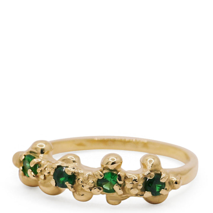 Gold ring with green gemstones on a white background