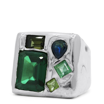 melty surface square signet ring cast in sterling silver with asymmetrically placed gemstones, which include: an XL Green Tourmaline gemstone, and 3 smaller Green Tourmaline gems in assorted sizes and shades, and 1 tear drop shaped blue Sapphire.