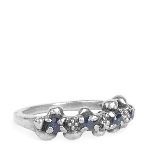 Silver ring with embedded stones on a white background