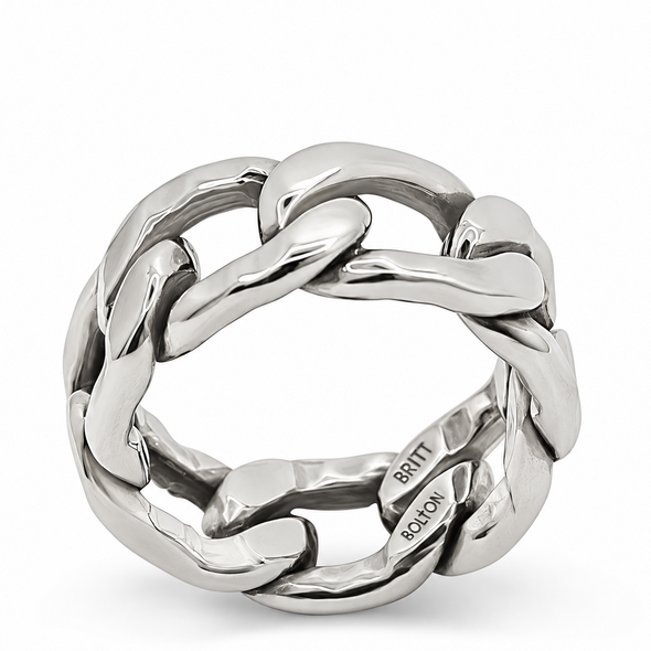 A chunky silver chain-link ring with a polished finish, featuring interlocking links and a visible 'BRITT SCLOON' engraving on the inside, set against a plain white background.