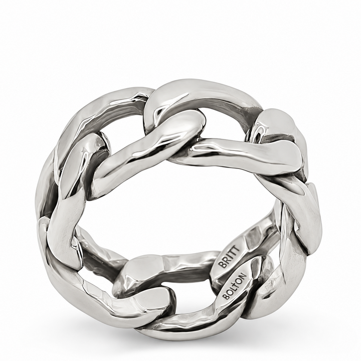 A chunky silver chain-link ring with a polished finish, featuring interlocking links and a visible 'BRITT SCLOON' engraving on the inside, set against a plain white background.