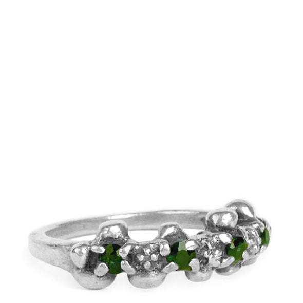 Silver ring with green gemstones on a white background