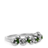 Silver ring with green gemstones on a white background