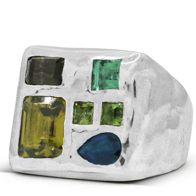 melty surface square signet ring cast in sterling silver with asymmetrically placed gemstones, which include: emerald cut Peridot gemstone, and 3 Green Tourmaline gem, 1 rectangle smokey quartz, and 1 tear drop shaped blue Sapphire.