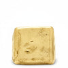 A square signet ring made of 14k solid gold, with a textured, imperfections surface.