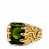 A gold signet ring featuring a large, rectangular emerald-cut green gemstone and a textured, flame-like gold band, shown on a plain white background.