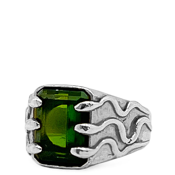 Silver ring with a green gemstone on a white background