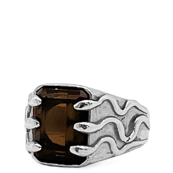 Silver ring with a brown gemstone on a white background