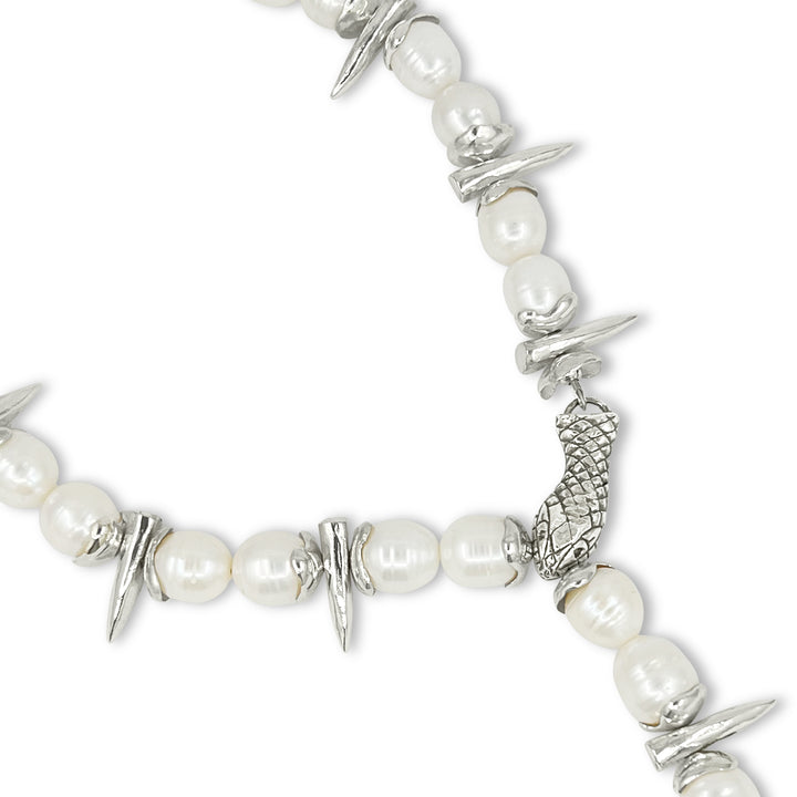 Bracelet with pearls and silver spikes on a white background
