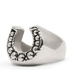 Silver horseshoe-shaped ring with embedded stones on a white background