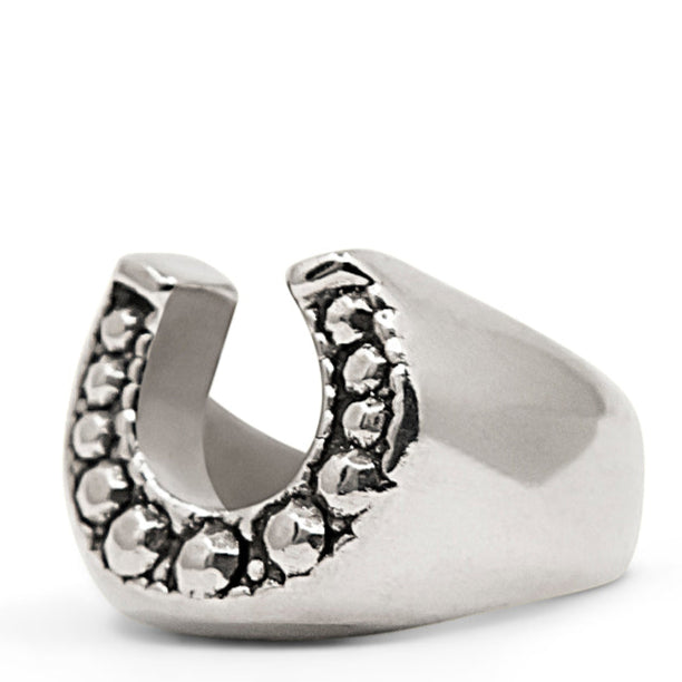 Silver horseshoe-shaped ring with embedded stones on a white background