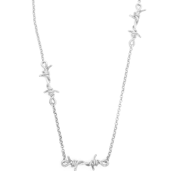 A silver necklace featuring three barbed wire link pendants on a Rolo chain.