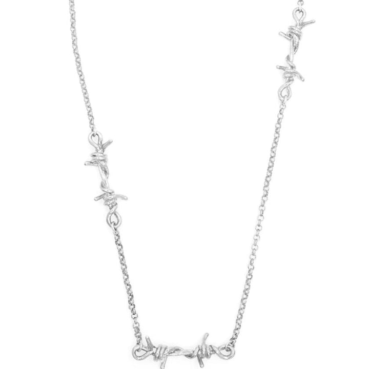 A silver necklace featuring three barbed wire link pendants on a Rolo chain.
