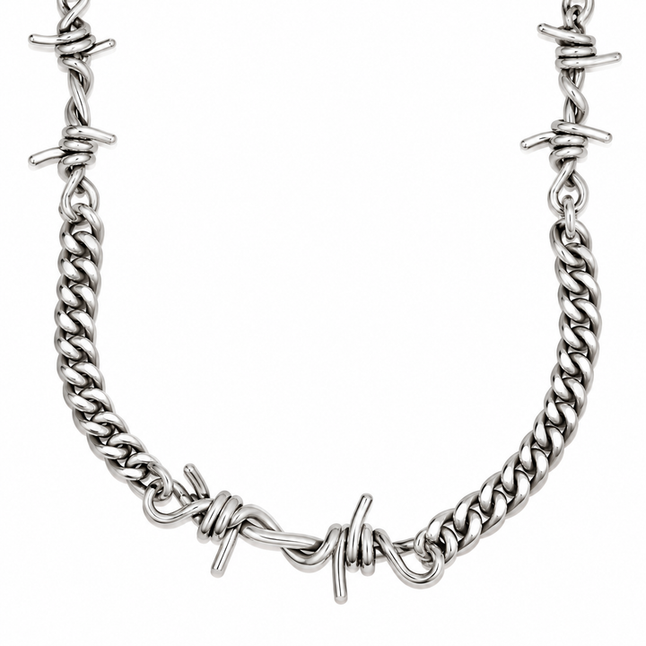 A silver-toned metal curb chain necklace featuring integrated barbed wire details, shown against a plain white background.