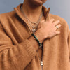 Person wearing a brown zip-up sweater against a plain background
