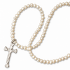 A strand of irregular white freshwater pearls with a textured silver crucifix pendant, arranged on a clean white background.