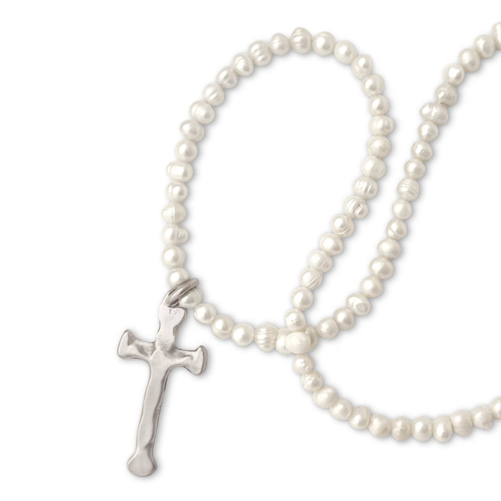 Pearl necklace with a silver cross pendant on a white background