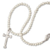 Pearl necklace with a cross pendant on a white background