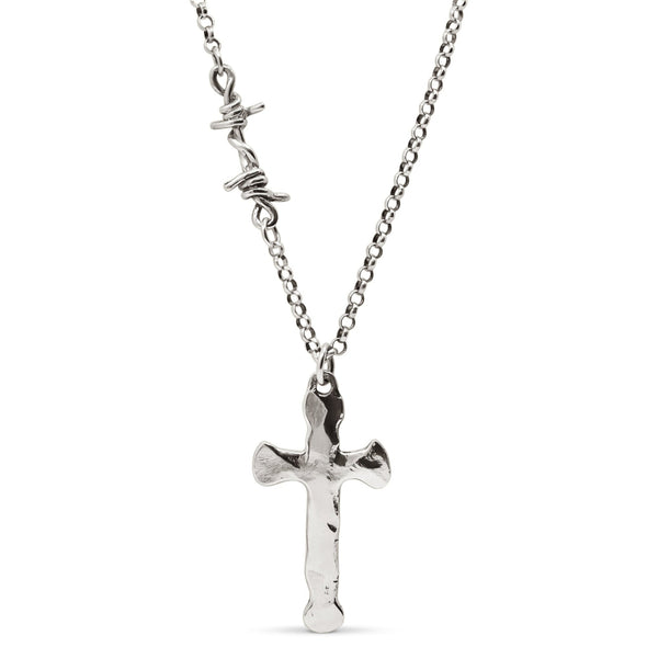 A sterling silver cross pendant necklace with a hammered finish on a heavy Rolo chain featuring a single barbed wire link.