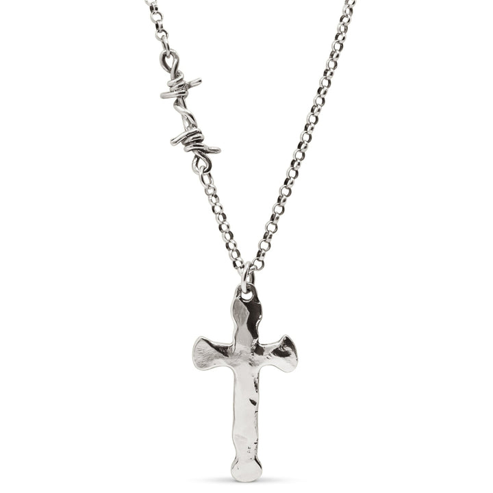 A sterling silver cross pendant necklace with a hammered finish on a heavy Rolo chain featuring a single barbed wire link.