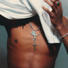 Close-up of a person wearing a white t-shirt, showcasing a sterling silver crucifix dagger necklace with a barbed wire link on a heavy chain.