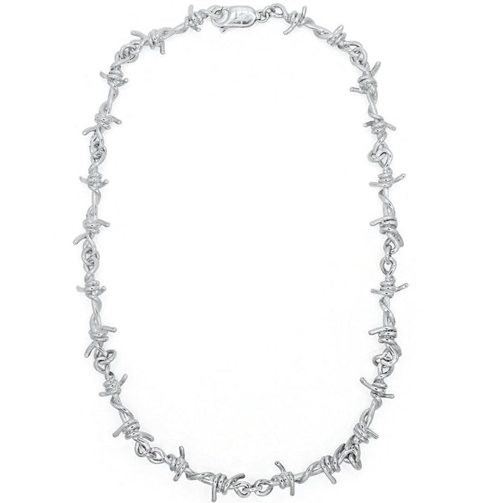 Silver barbed wire necklace on a white background