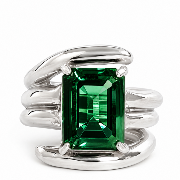 A silver wrap-style ring featuring a large rectangular emerald-cut green gemstone in a four-prong setting, photographed on a clean white background.