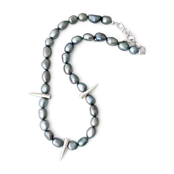 Necklace with greyish green pearls and silver spike-like elements on a white background