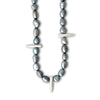Necklace with gray beads and silver spike-like elements on a white background