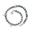 Gray pearl necklace with silver clasp on a white background