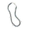 Necklace with gray beads and silver spike-like elements on a white background