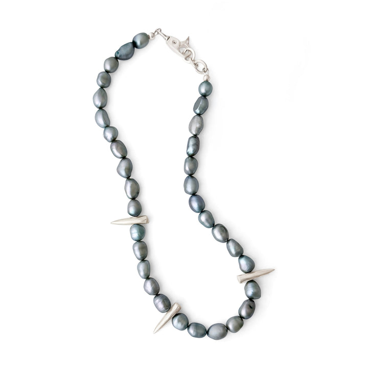 Necklace with gray beads and silver spike-like elements on a white background
