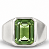 A silver signet ring featuring a large, rectangular emerald-cut green gemstone, shown against a plain white background.