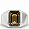 A silver signet ring featuring a large, faceted rectangular smoky brown gemstone, shown on a clean white background.