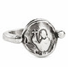 A silver-toned metal ring featuring a circular medallion with an embossed figure holding a cross, photographed on a clean white background.