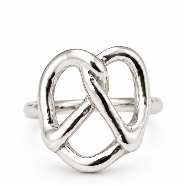 A sterling silver ring featuring a stylized, open pretzel knot design, photographed against a seamless white background.