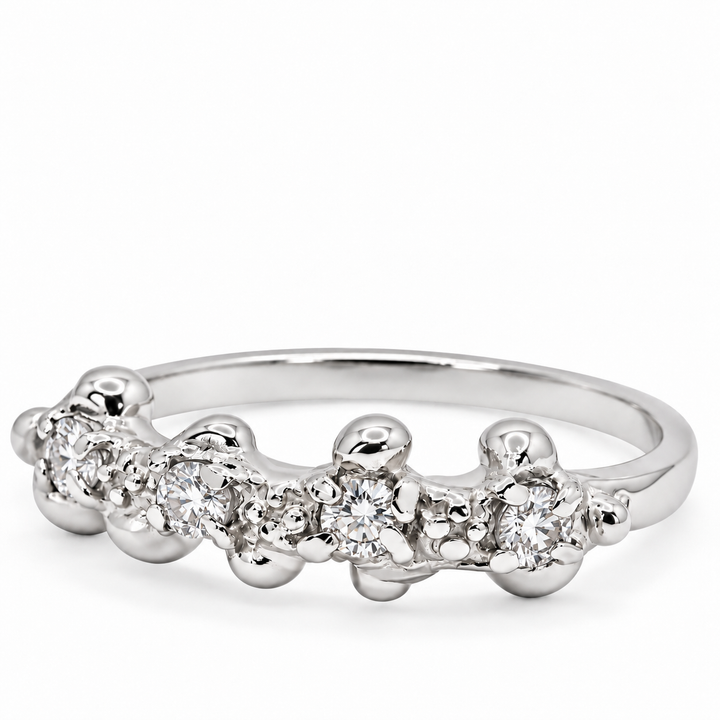 A silver band ring featuring a row of clear round-cut gemstones set in a bubbly, clustered design, photographed on a clean white background.