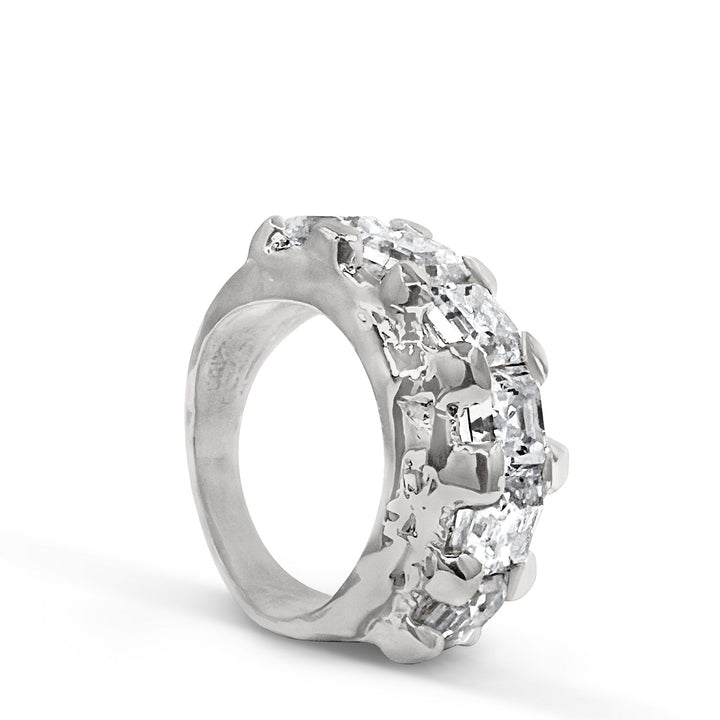 Silver ring with clear gemstones on a white background
