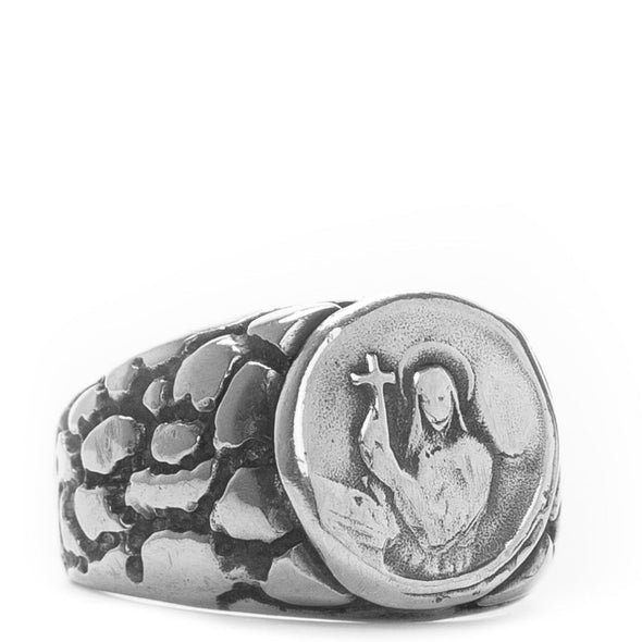 Silver ring with engraved design on a white background
