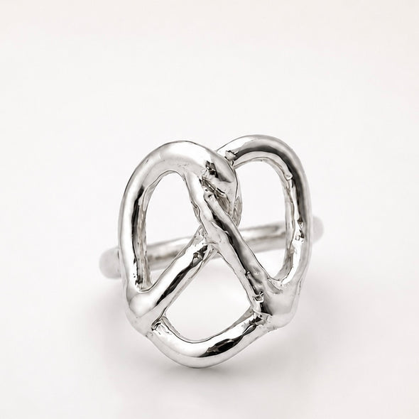 Silver pretzel ring on a white background
