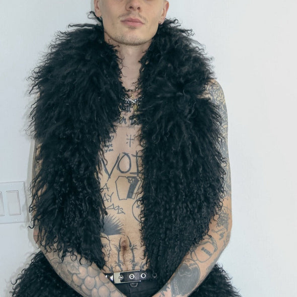 male model posing in white background wearing our mongolian lamb boa in black