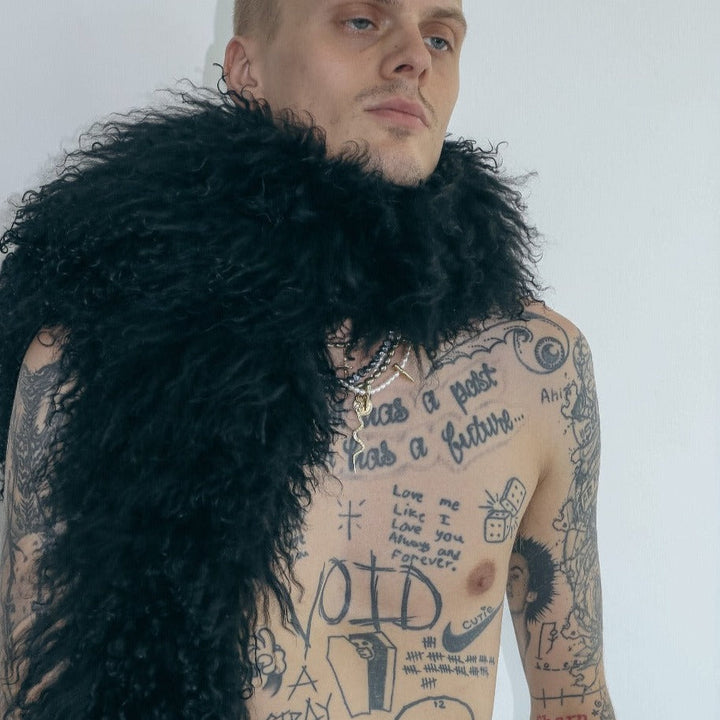 male model standing in front of white background wearing our mongolian lamb boa
