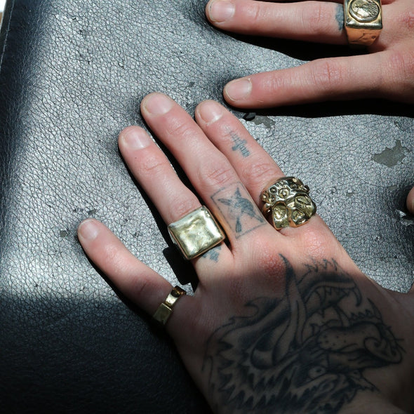 close up shoot of hands wearing our zombie head ring