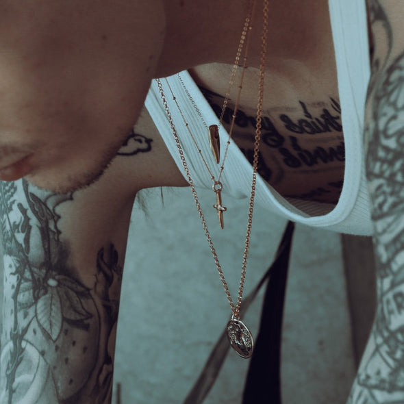 close up shot of model's neck wearing our momento mori coin necklace