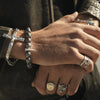 close shot of hands wearing our black pearl spike bracelet